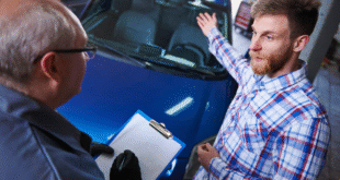 Mechanic performing a pre purchase vehicle check on a BMW