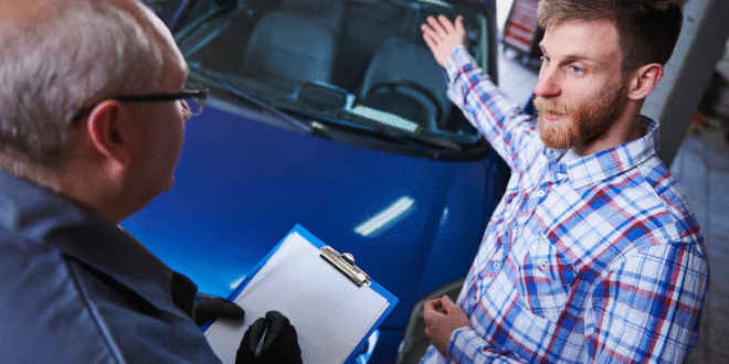 Mechanic performing a pre purchase vehicle check on a BMW
