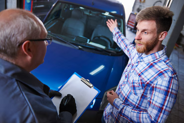 Mechanic performing a pre purchase vehicle check on a BMW